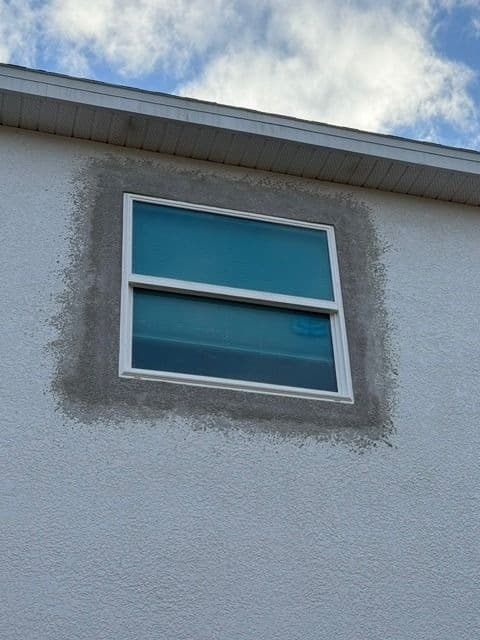 Stucco repair around window before exterior paint